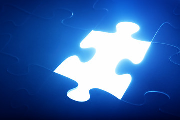 Jigsaw puzzle piece missing. Light glowing. Solution