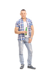 Casual young man holding a bottle of beer