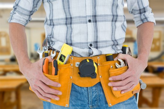 Image of technician with tool belt around waist