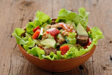 Vegetable salad with white beans, rye toasts, tomatoes, cucumber