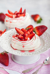 Pavlova meringue cake decorated with fresh strawberry
