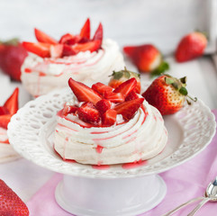 Pavlova meringue cake decorated with fresh strawberry