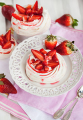 Pavlova meringue cake decorated with fresh strawberry