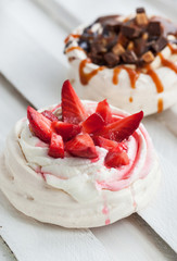 Two different versions of Pavlova meringue cake