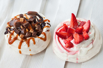 Two different versions of Pavlova meringue cake