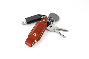 Many keys and flashdrive on white background
