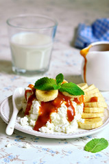Cottage cheese with banana slices and caramel sauce.