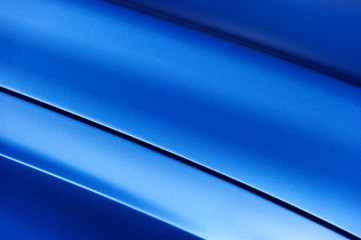 Surface of blue sport sedan car metal hood; vehicle bodywork