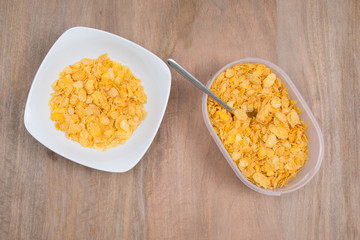 Cornflakes in porcelain bowl isolated on white background