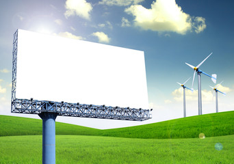 Blank billboard  with green grass and wind turbine