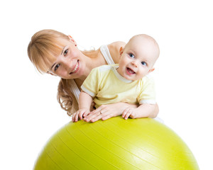 mother and her baby having fun with gymnastic ball