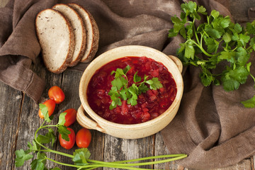 Red borscht with  parsley in ceramic  bowl