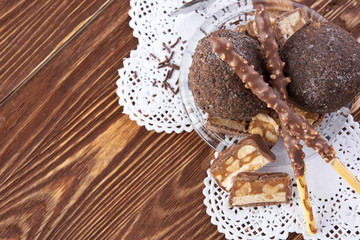 Cupcake with chocolate on wooden background
