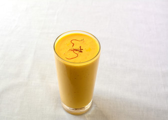 Mango lassi in a glass, a sweet Indian smoothie