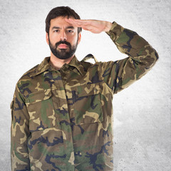 Soldier saluting over white background