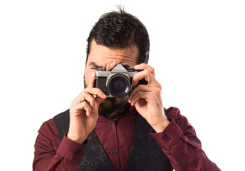 Man wearing waistcoat photographing