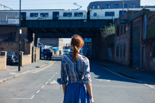 Woman walking in the street near trainline