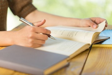 Writing. Young women and education, close up of hands of girl