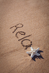 relax drawing on beach. Summer concept with starfish on sands.