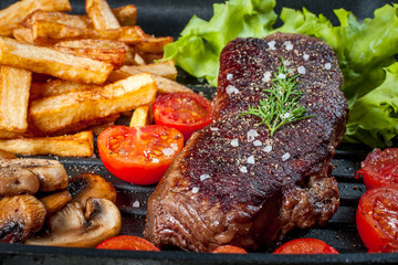 Fried steak with fries .