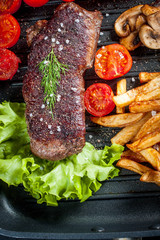 Fried steak with fries .