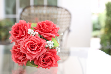 Beautiful roses in a ceramic vase on a table.
