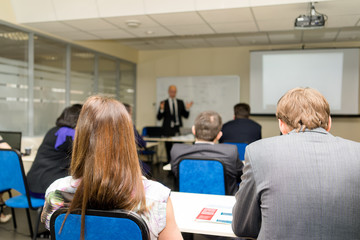 The audience listens to the acting in a conference hall