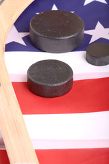 Hockey equipment including a stick and puck on an American flag