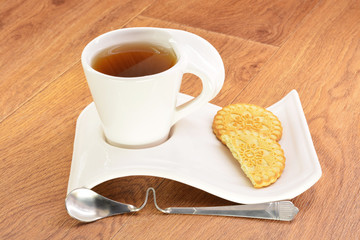 Black tea in a white mug and cookies