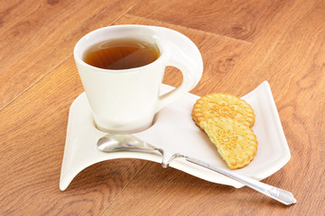 Black tea in a white mug and cookies