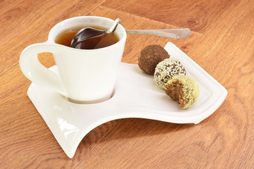 Black tea in a white mug and cake