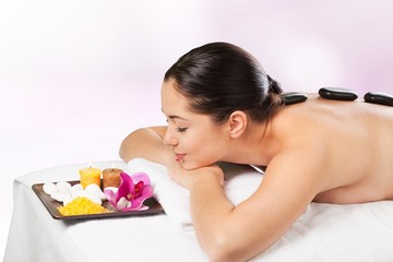 Rock. Picture of woman in spa salon with hot stones