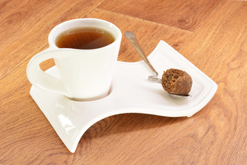 Black tea in a white mug and cake