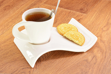 Black tea in a white mug and cookies