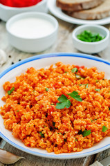 millet porridge with tomato sauce, garlic and parsley