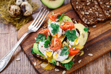 Bruschetta with tomato, avocado and quail egg
