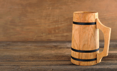 Wooden mug on wooden background