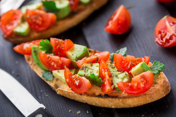 Bruschetta with tomato, avocado and herbs