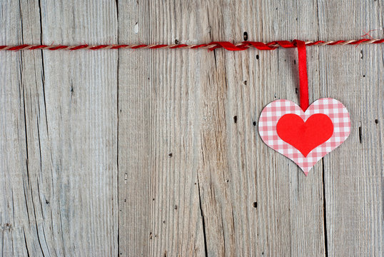 Paper heart on old wooden background