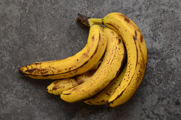 Bananas on dark, stone table