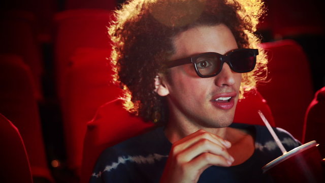 Happy young man watching a film