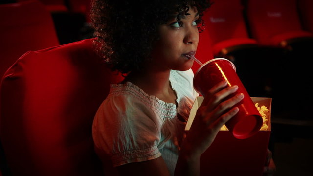 Engrossed young woman watching a movie