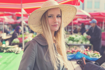 Portrait of attractive blonde girl with straw hat.