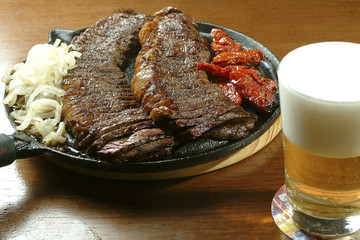 Barbecue served with beer.