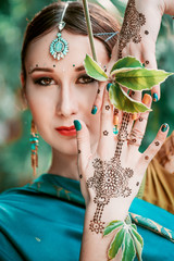 Beautiful woman with henna tattoo mehendi