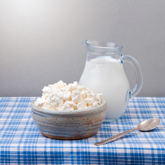 Cottage cheese and milk on tablecloth. Jewish holiday Shavuot