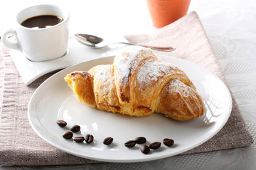 Breakfast with coffee and croissants