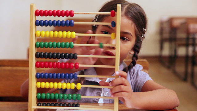 Cute pupil learning maths with an abacus