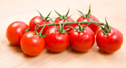 Tomatoes cherry branch on a wooden board