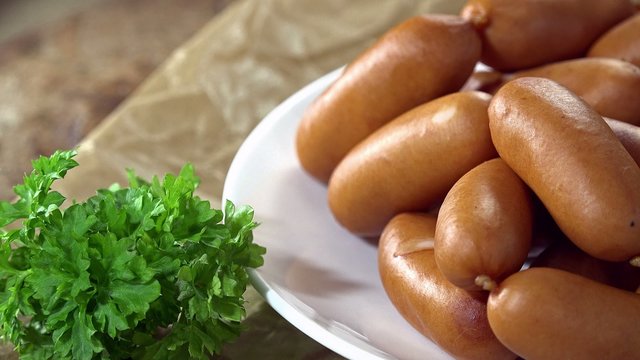 Portion of mini Sausages (not seamless loopable 4K UHD footage)